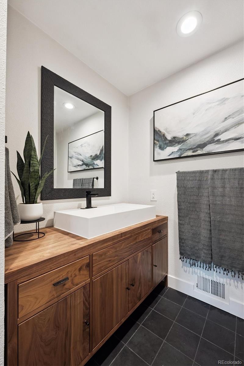 3675 South Hibiscus Way Denver, CO 80237 - Photo 20 of 50 a spacious bathroom with a double vanity sink and a mirror
