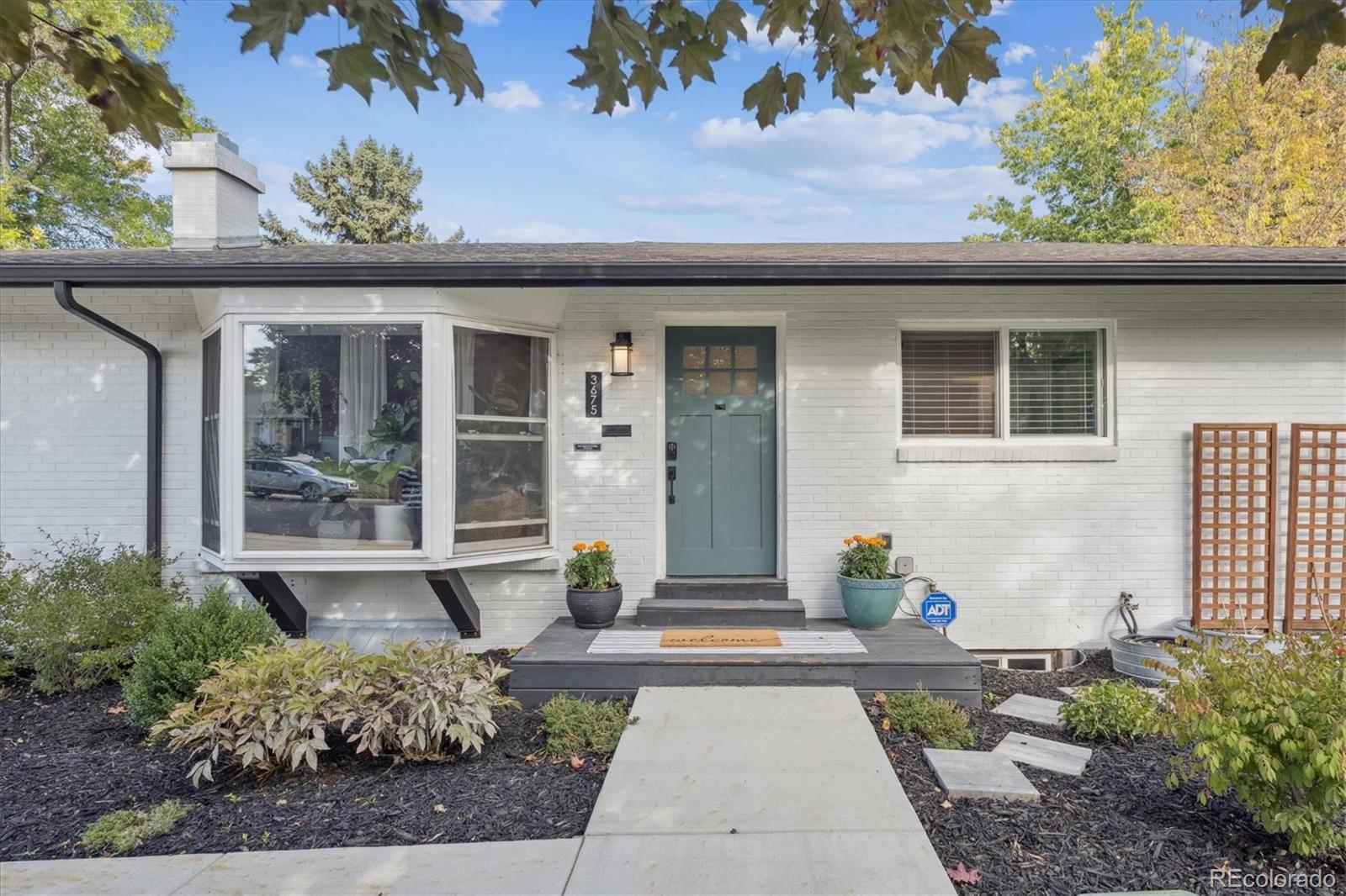 3675 South Hibiscus Way Denver, CO 80237 - Photo 2 of 50 a front view of a house with garden