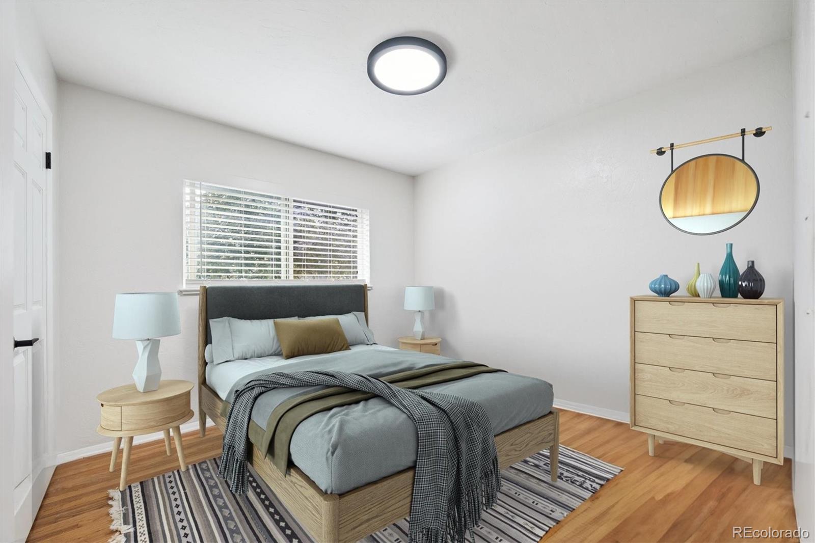 3675 South Hibiscus Way Denver, CO 80237 - Photo 22 of 50 a bedroom with a bed and wooden floor