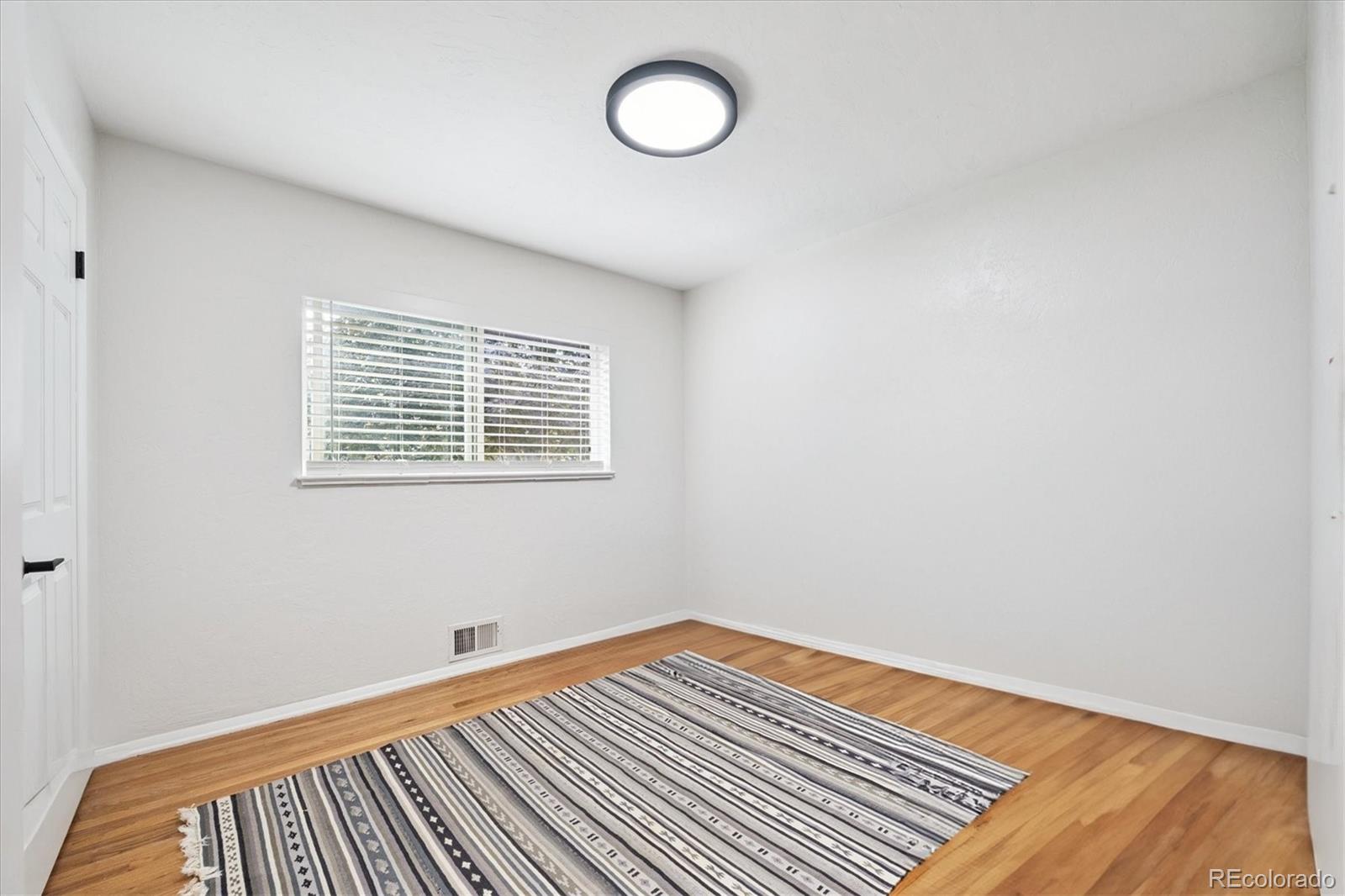 3675 South Hibiscus Way Denver, CO 80237 - Photo 23 of 50 a view of a room with wooden floor and window