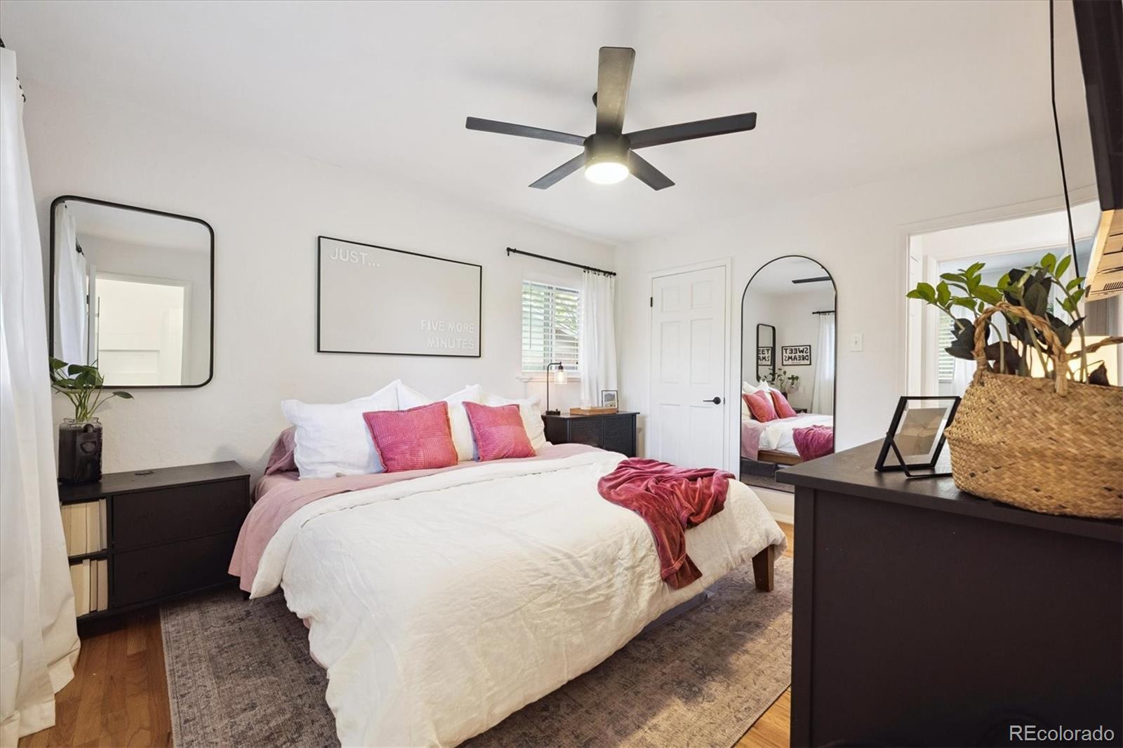 3675 South Hibiscus Way Denver, CO 80237 - Photo 25 of 50 a bedroom with a bed a chandelier and a mirror