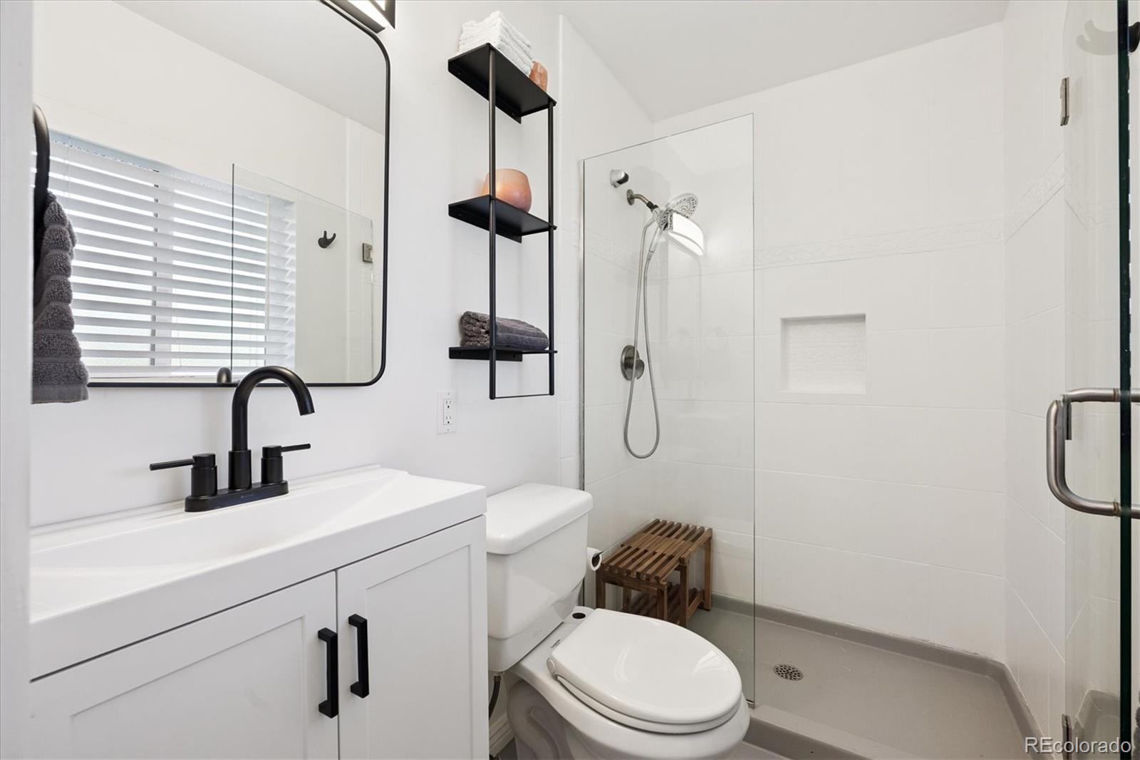 3675 South Hibiscus Way Denver, CO 80237 - Photo 26 of 50 a bathroom with a toilet sink and shower