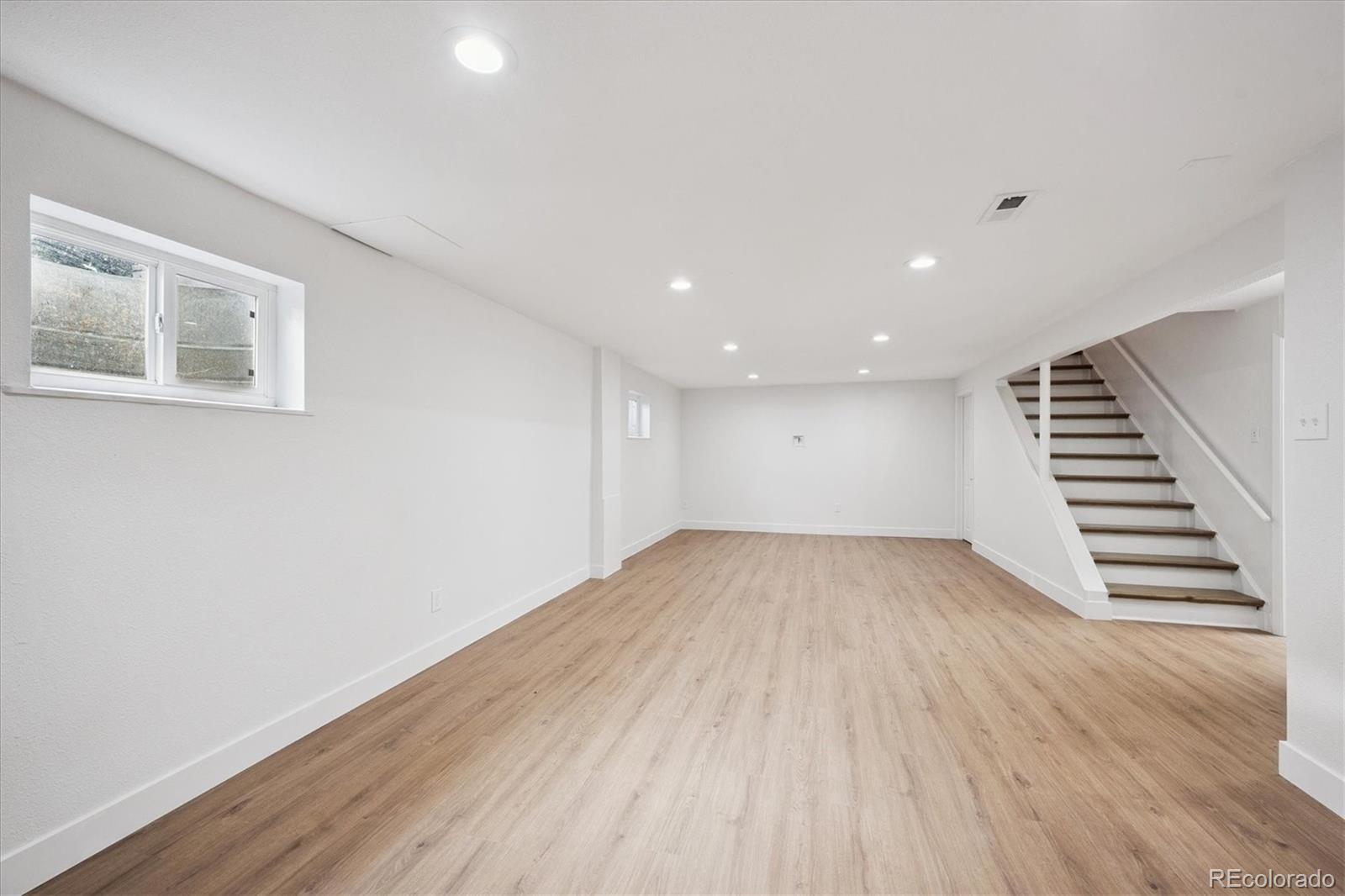 3675 South Hibiscus Way Denver, CO 80237 - Photo 29 of 50 a view of an empty room with wooden floor and entryway