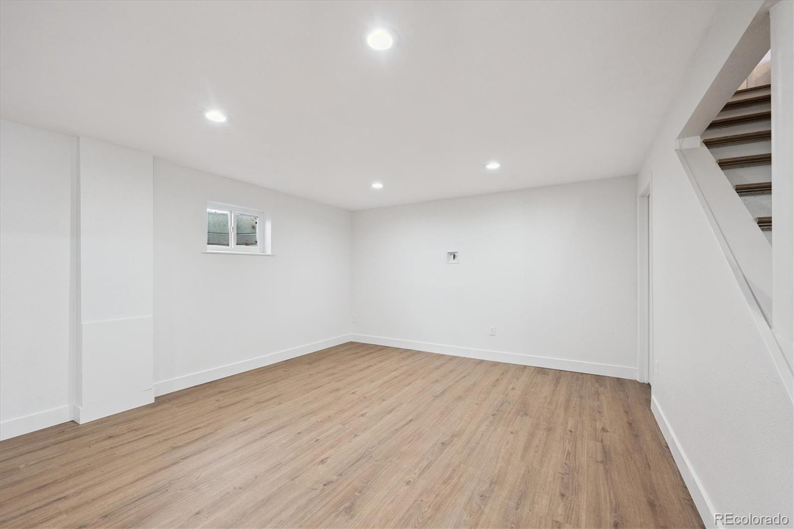 3675 South Hibiscus Way Denver, CO 80237 - Photo 31 of 50 a view of an empty room with wooden floor and entryway