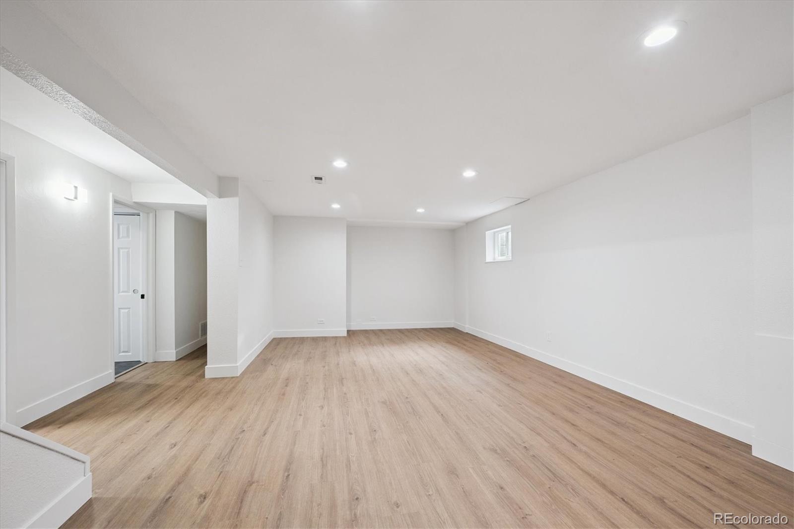 3675 South Hibiscus Way Denver, CO 80237 - Photo 32 of 50 a view of an empty room with wooden floor