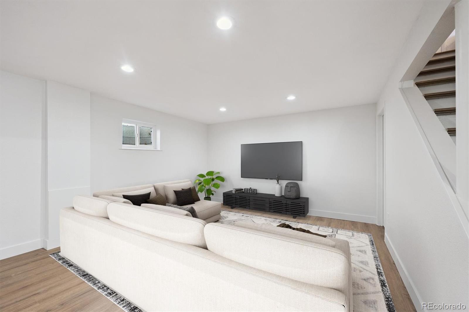 3675 South Hibiscus Way Denver, CO 80237 - Photo 34 of 50 a room with furniture and a flat screen tv