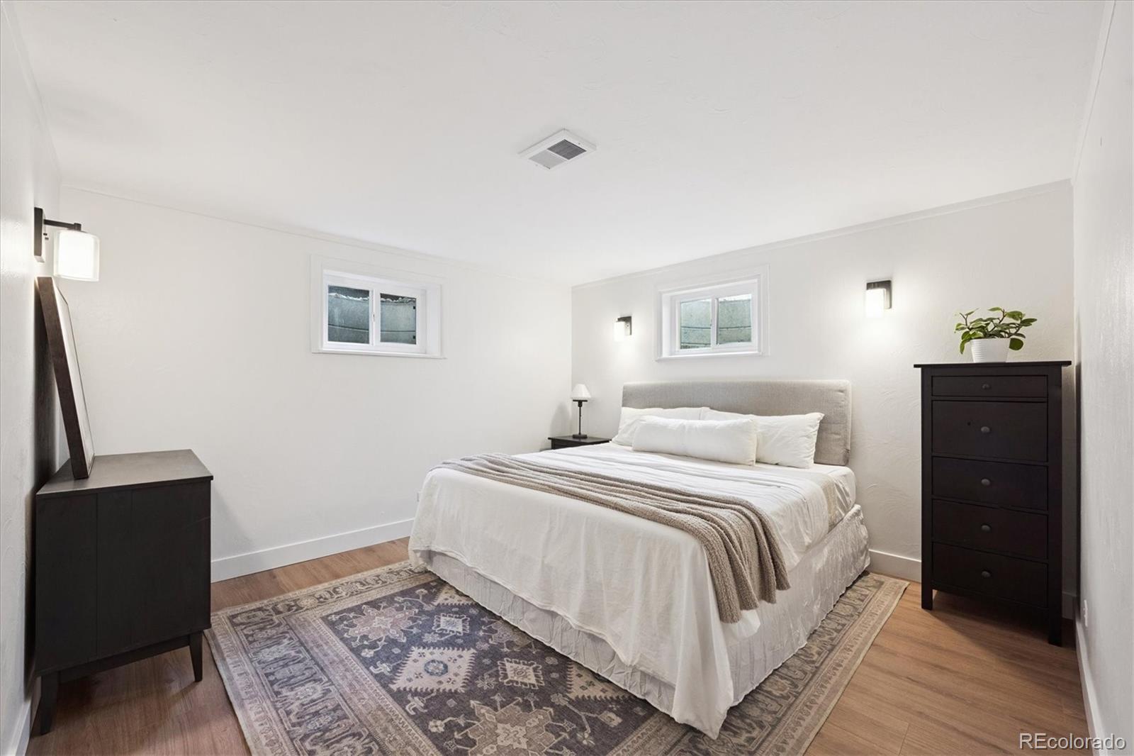 3675 South Hibiscus Way Denver, CO 80237 - Photo 38 of 50 a bedroom with a bed and a flat screen tv