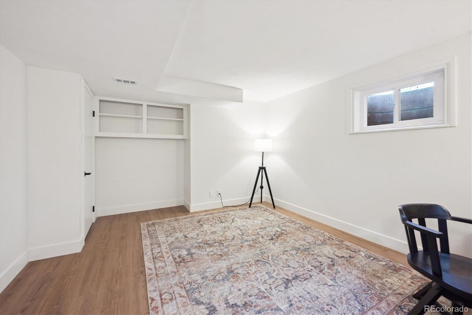 3675 South Hibiscus Way Denver, CO 80237 - Photo 39 of 50 a view of a livingroom with wooden floor and a potted plant