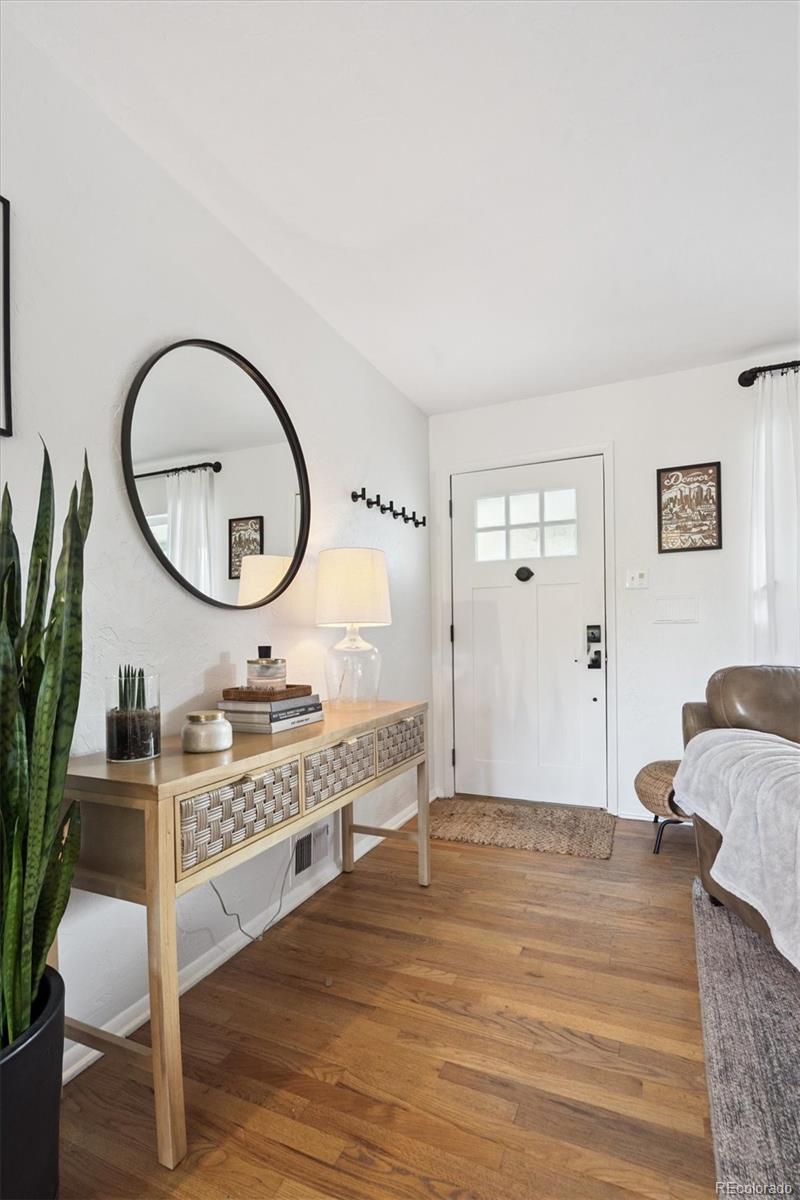 3675 South Hibiscus Way Denver, CO 80237 - Photo 4 of 50 a bedroom with a bed mirror and a potted plant on table