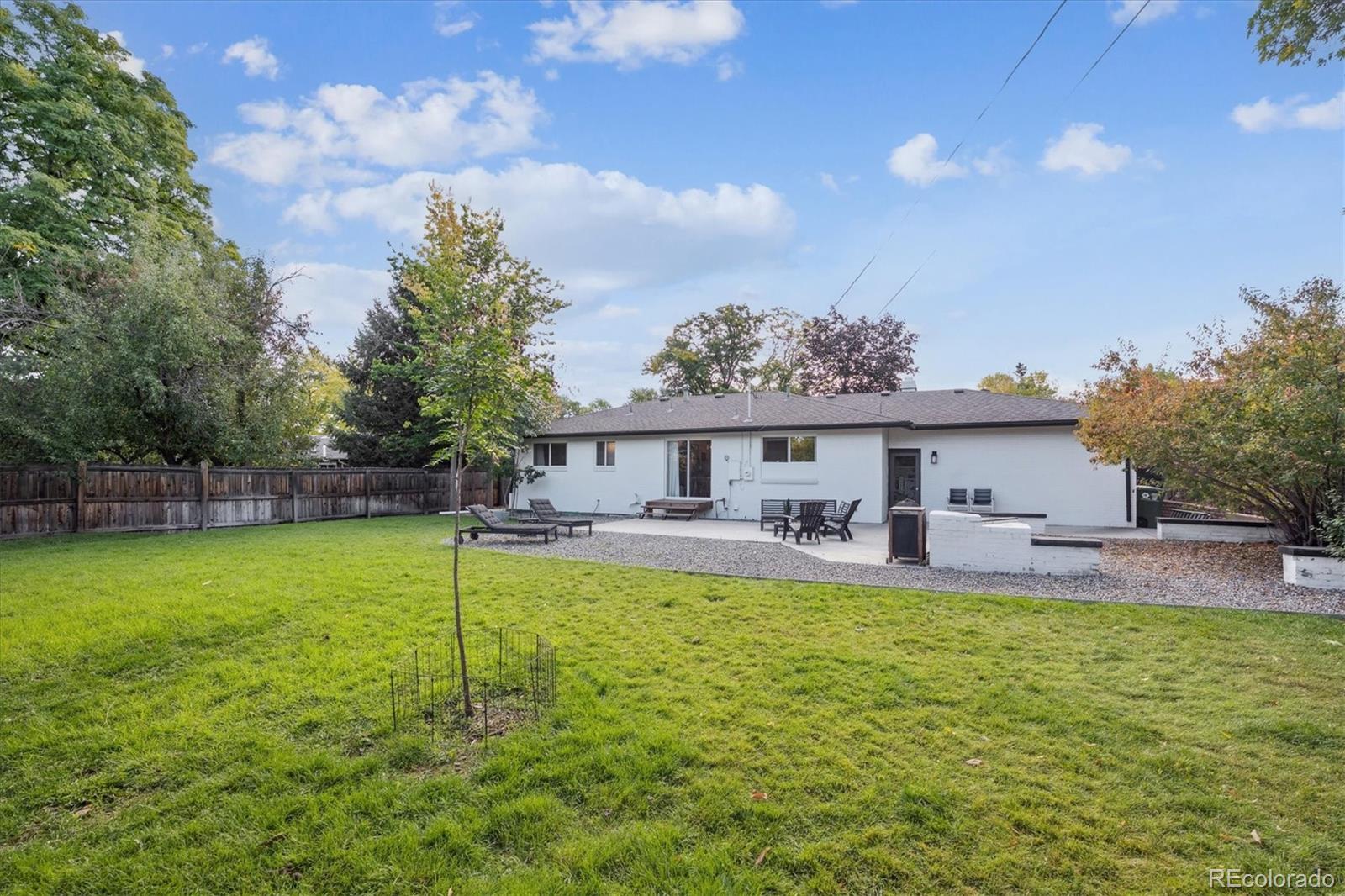 3675 South Hibiscus Way Denver, CO 80237 - Photo 46 of 50 a view of a house with a yard porch and sitting area