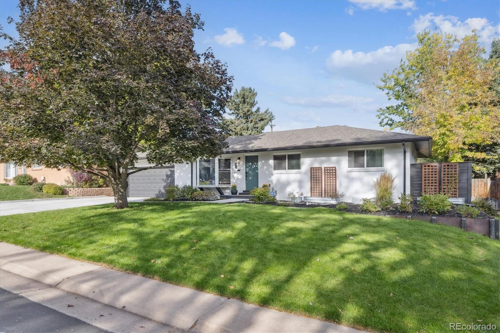 3675 South Hibiscus Way Denver, CO 80237 - Photo 6 of 50 a front view of a house with a garden