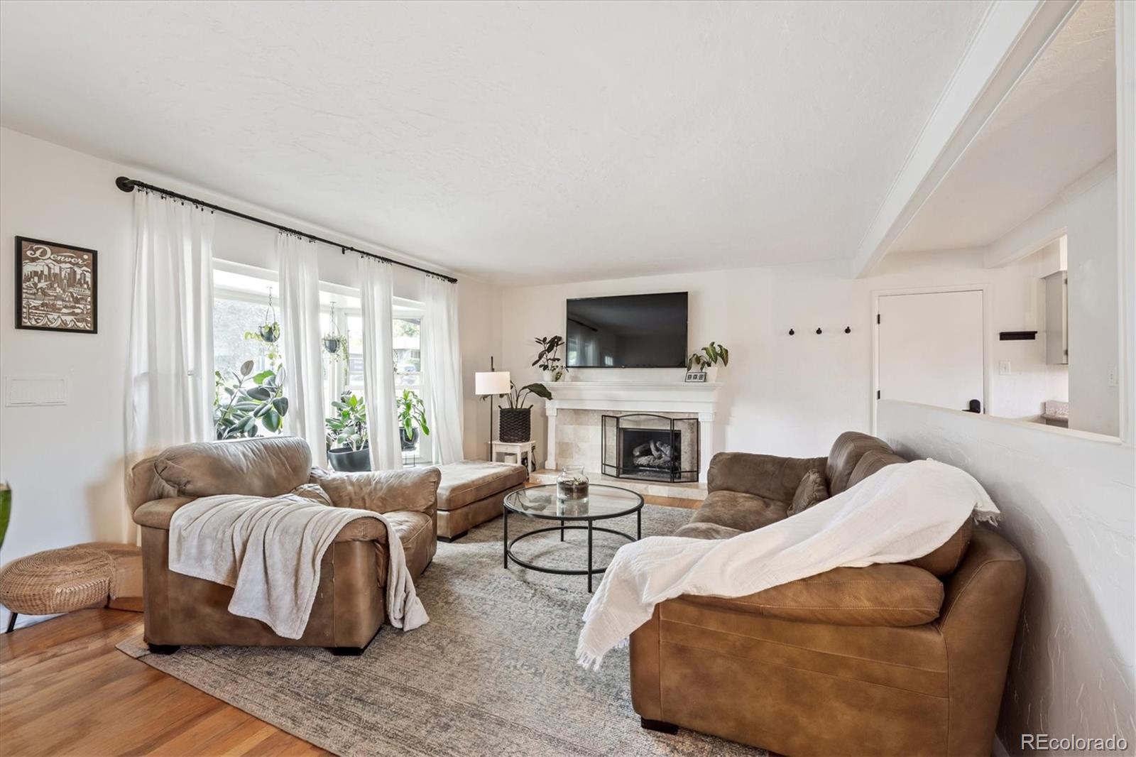 3675 South Hibiscus Way Denver, CO 80237 - Photo 7 of 50 a living room with furniture and a fireplace