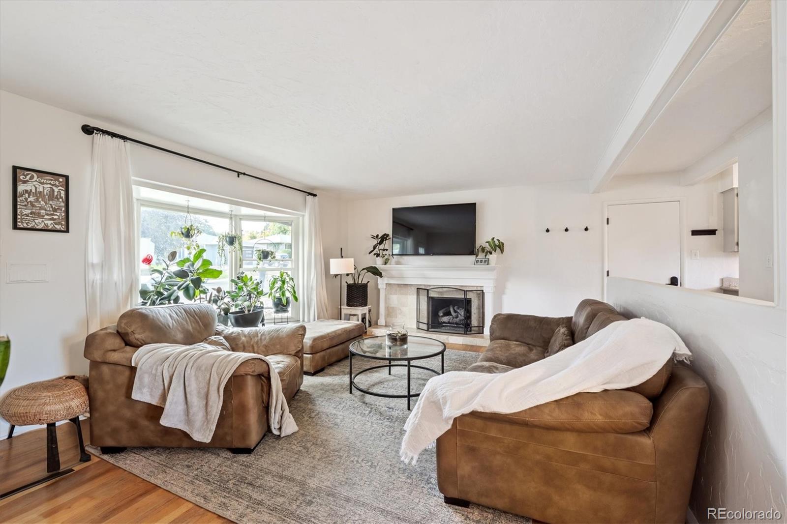 3675 South Hibiscus Way Denver, CO 80237 - Photo 8 of 50 a living room with furniture and a fireplace