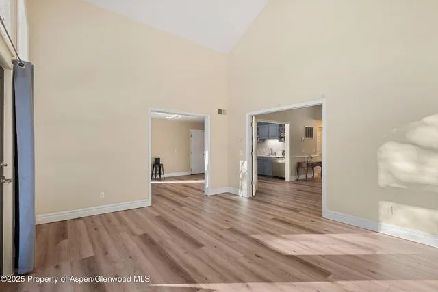 a dining room with furniture and a floor to ceiling window