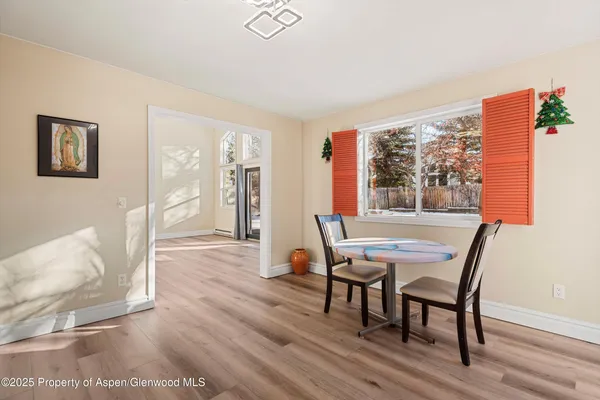 a dining room with furniture and wooden floor