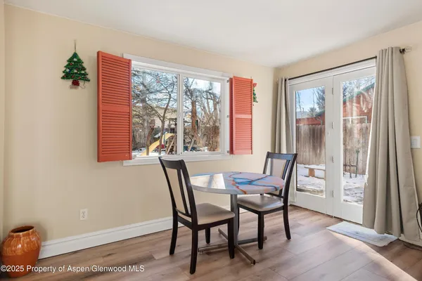 a view of a dining room with furniture and wooden floor