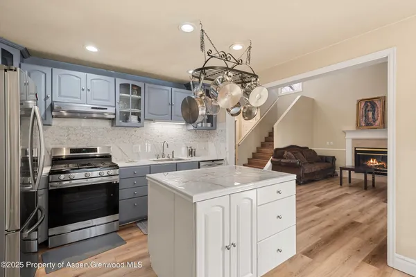 a kitchen with a stove a sink and a refrigerator
