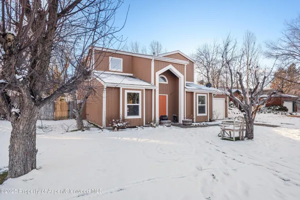 a view of a house with a snow on the road
