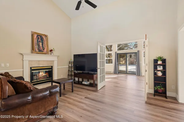 a living room with furniture a flat screen tv and a fireplace