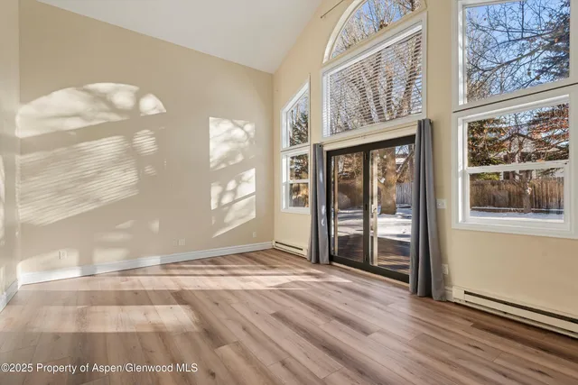 a dining room with furniture and wooden floor
