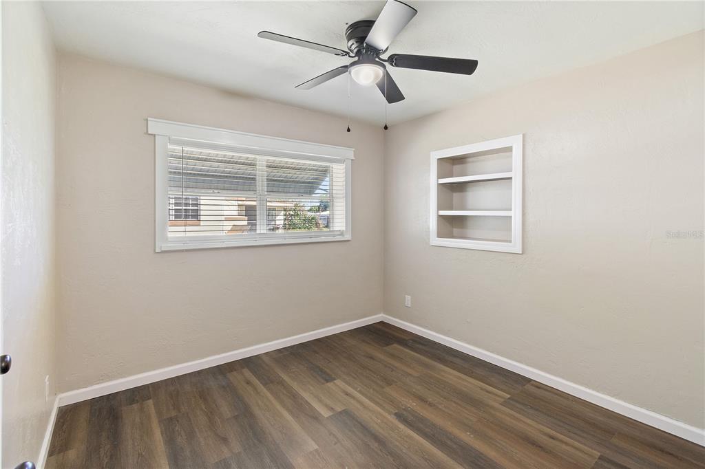 319 Thomas Avenue Frostproof, FL 33843 - Photo 16 of 47 a view of empty room with wooden floor and fan