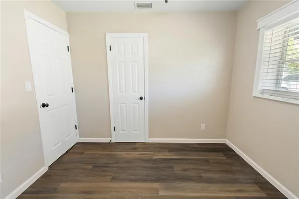 an empty room with wooden floor