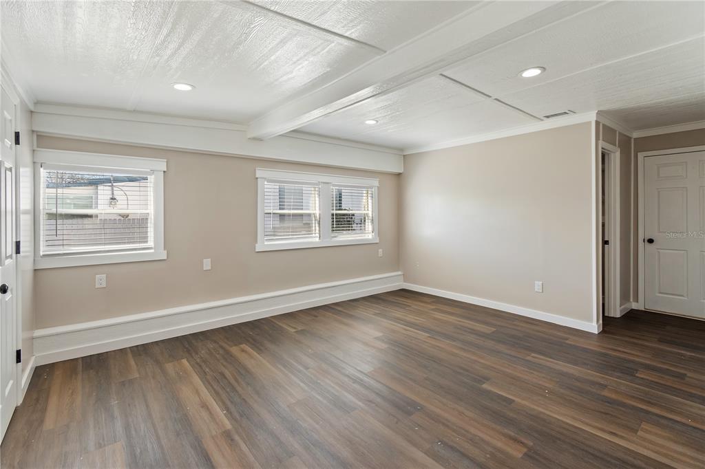 319 Thomas Avenue Frostproof, FL 33843 - Photo 18 of 47 an empty room with wooden floor and windows