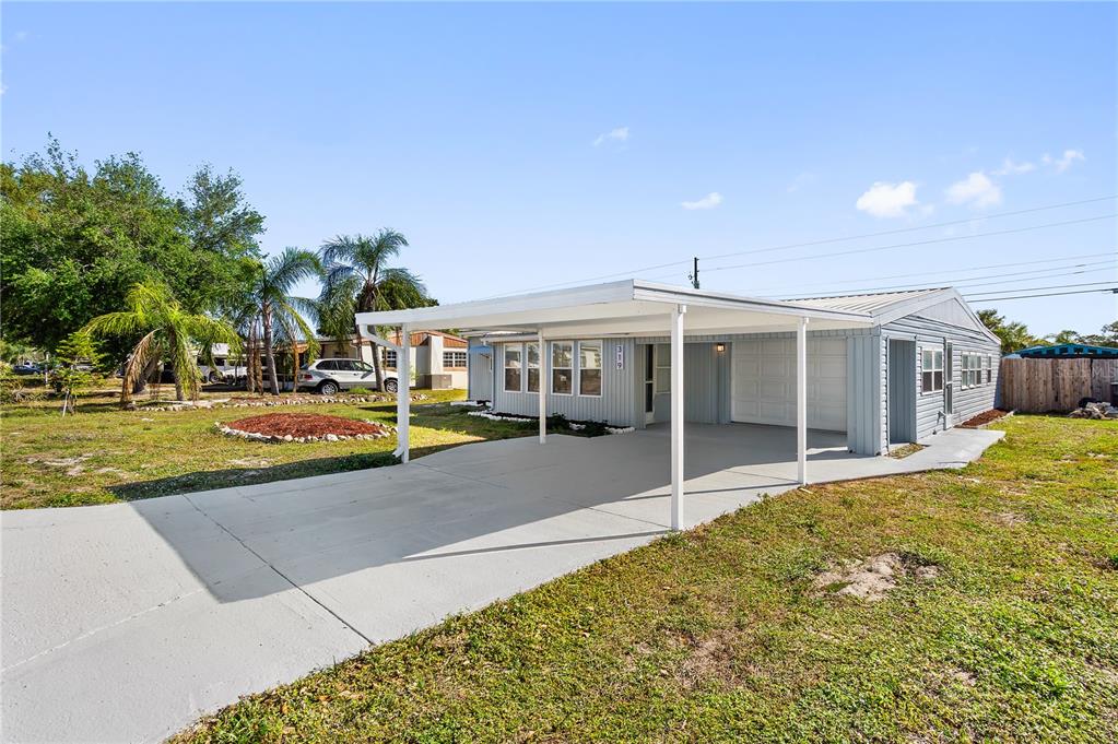 319 Thomas Avenue Frostproof, FL 33843 - Photo 2 of 47 a front view of a house with a yard
