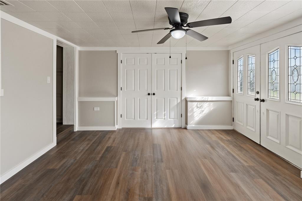 319 Thomas Avenue Frostproof, FL 33843 - Photo 3 of 47 a view of empty room with wooden floor and ceiling fan