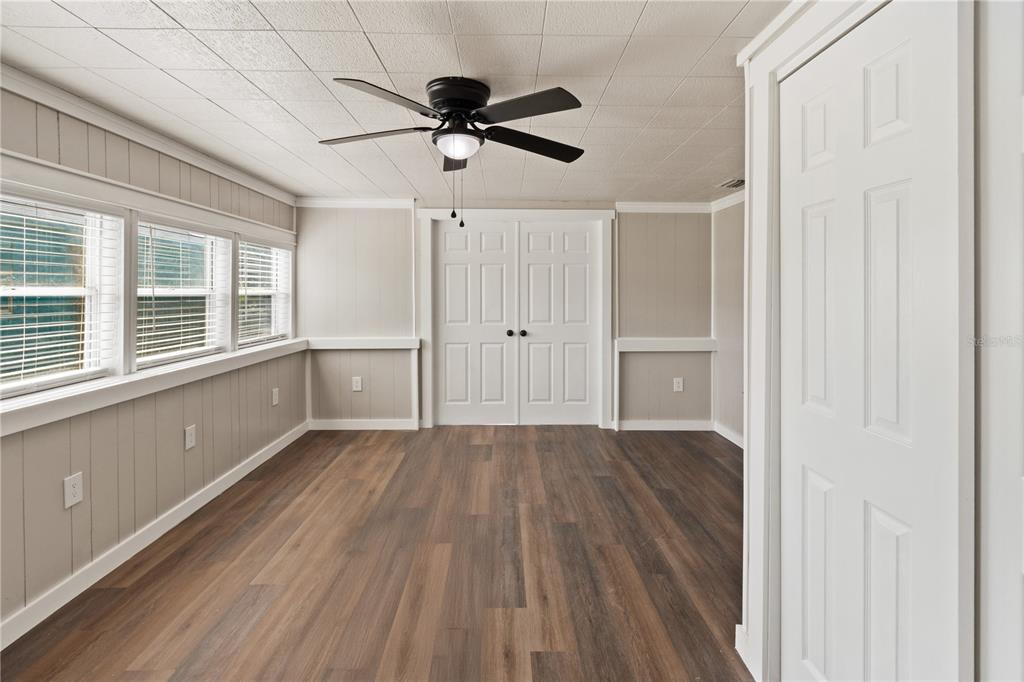 319 Thomas Avenue Frostproof, FL 33843 - Photo 7 of 47 a view of empty room with wooden floor and window