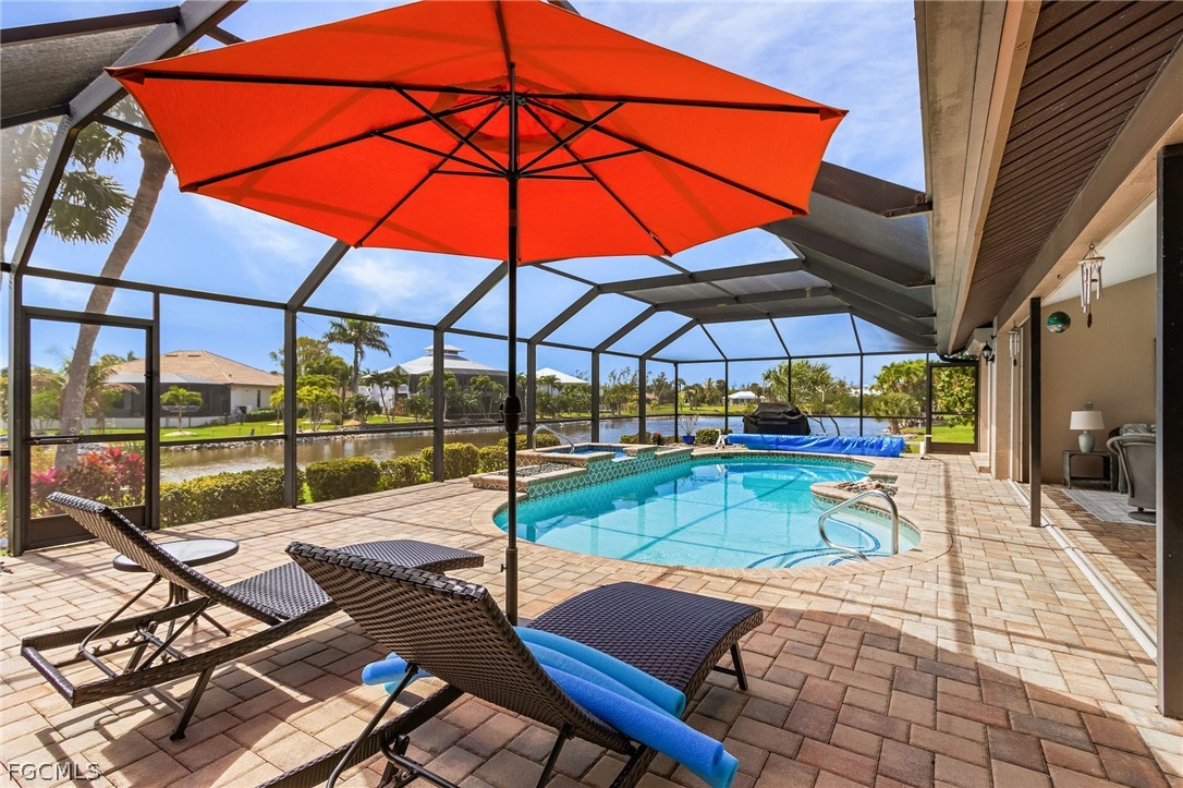 7747 Grande Pine Road Bokeelia, FL 33922 - Photo 34 of 45 a view of backyard with a patio and swimming pool