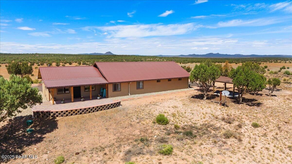 0 Juniperwood Ranch Ash Fork, AZ 86320 - Photo 31 of 35 a view of a patio with a table and chairs under an umbrella