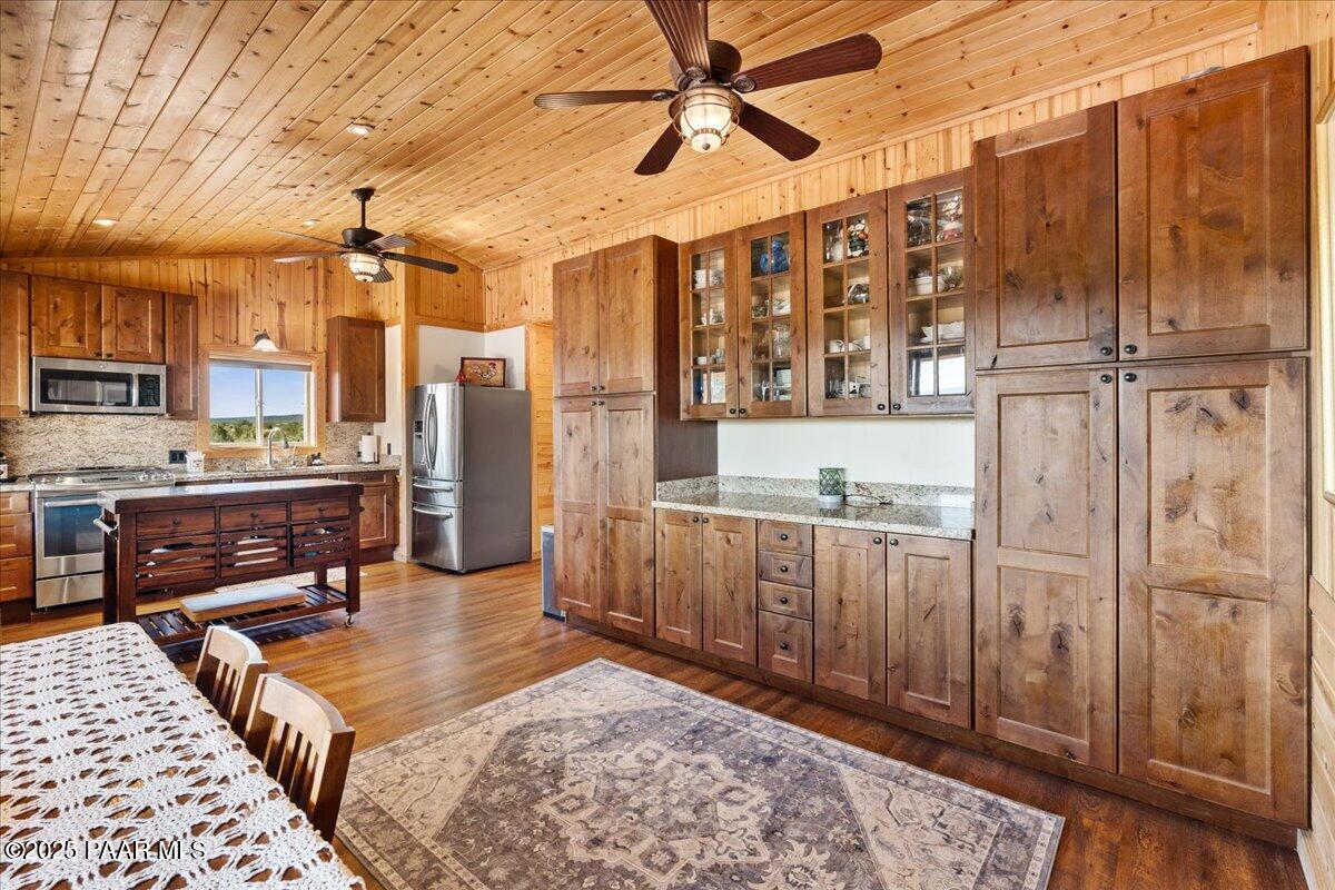 0 Juniperwood Ranch Ash Fork, AZ 86320 - Photo 7 of 35 a living room with stainless steel appliances kitchen island granite countertop a refrigerator and wooden cabinets