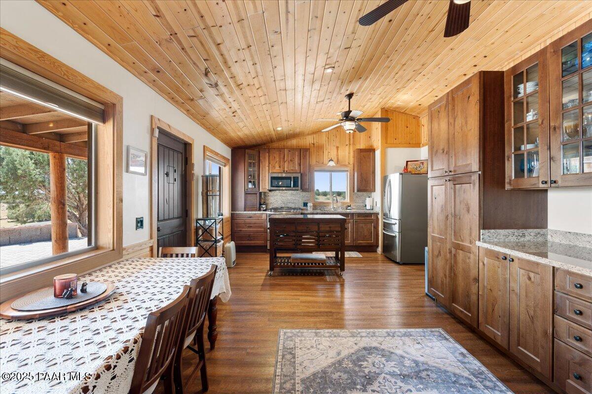 0 Juniperwood Ranch Ash Fork, AZ 86320 - Photo 8 of 35 a kitchen with stainless steel appliances granite countertop a stove a sink dishwasher a refrigerator and a dining table with wooden floor