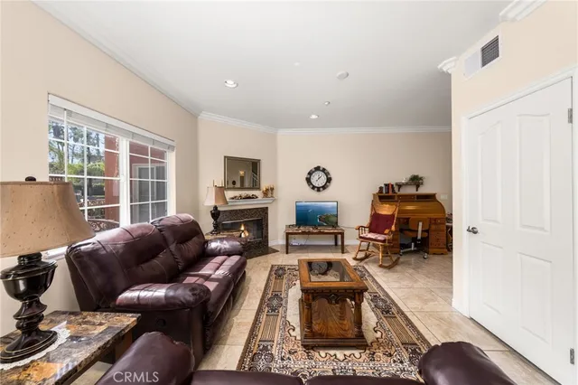 a living room with furniture a fireplace and a table