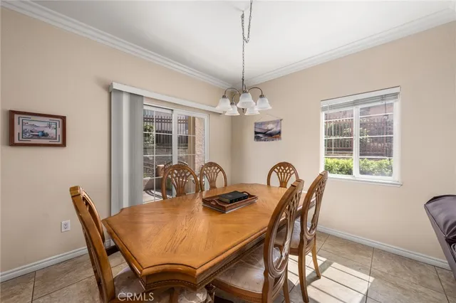 a dining room with furniture a chandelier and window