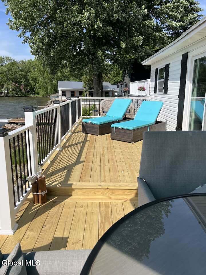 28363 Lotts Grove Road Lyme, NY 13622 - Photo 3 of 35 dock with lawn chairs