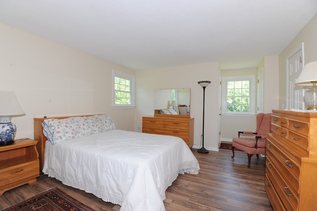 41 Chapel Road Amherst, MA 01002 - Photo 17 of 30 a bedroom with a bed and wooden floor