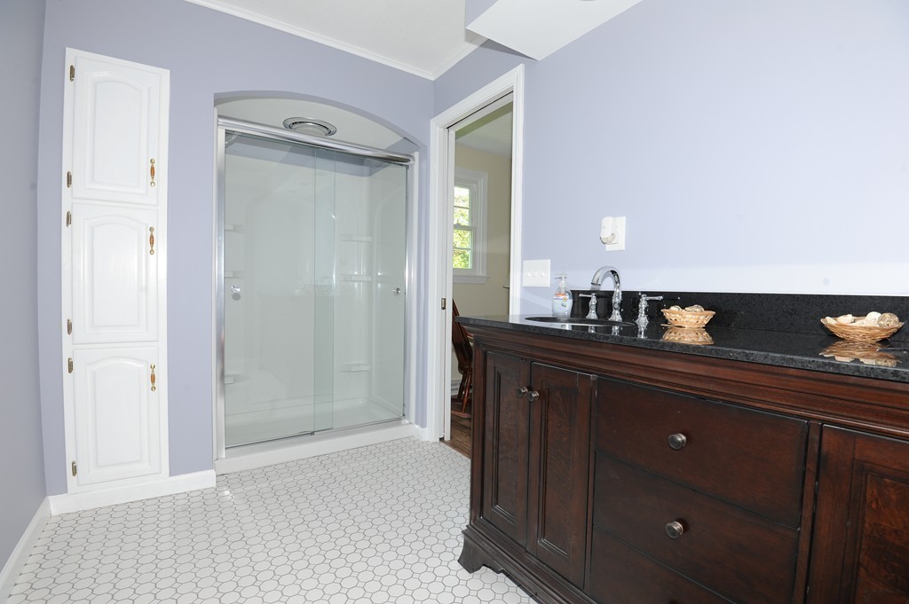 41 Chapel Road Amherst, MA 01002 - Photo 18 of 30 a bathroom with a granite countertop sink and a mirror