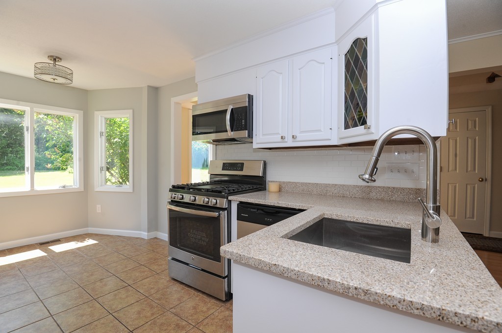 41 Chapel Road Amherst, MA 01002 - Photo 2 of 30 a kitchen with granite countertop a stove and a sink