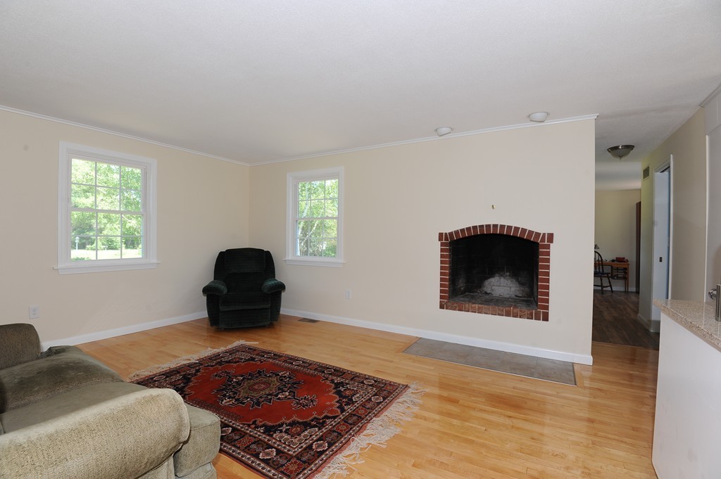 41 Chapel Road Amherst, MA 01002 - Photo 4 of 30 a living room with a fireplace and a rug
