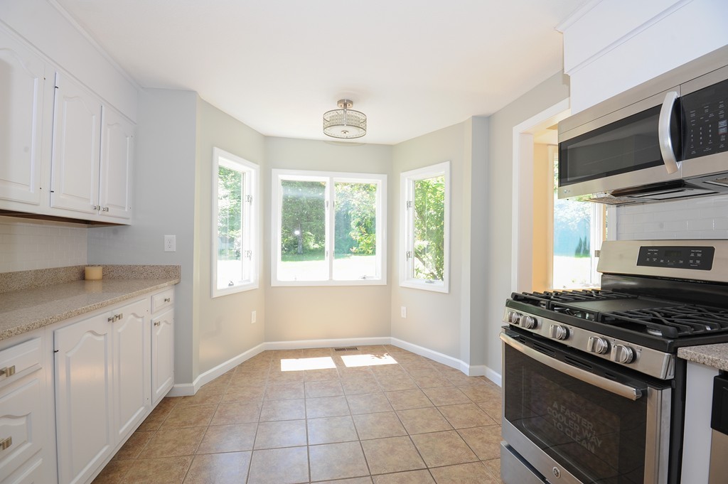 41 Chapel Road Amherst, MA 01002 - Photo 6 of 30 a kitchen with granite countertop a stove a sink and a microwave