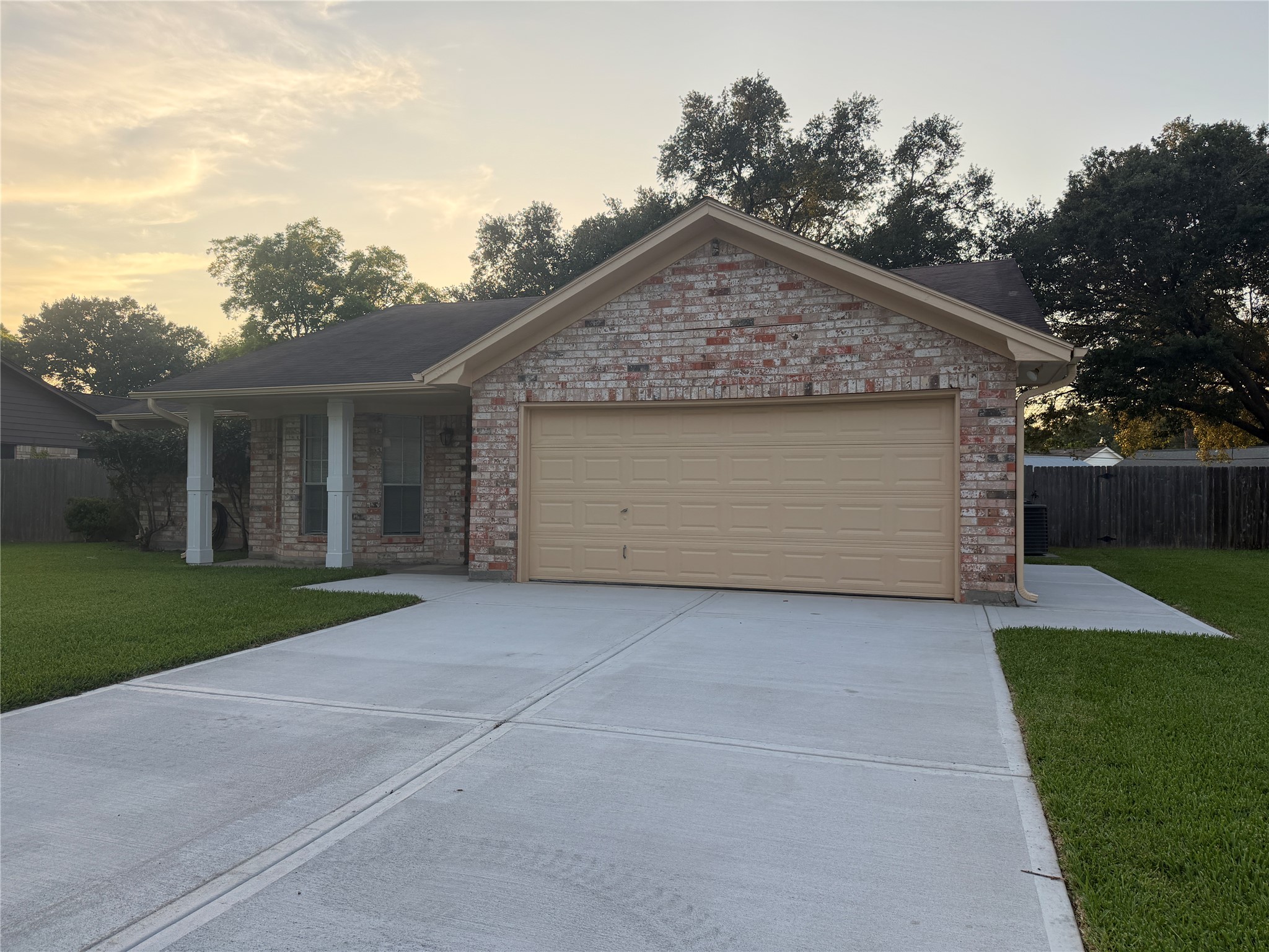 3815 Avenue R Rosenberg, TX 77471 - Photo 2 of 14 front view of house with a yard and trees all around