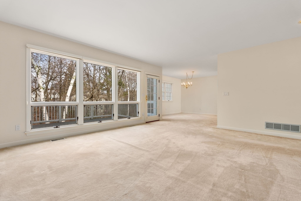 3 Parker Ridge Way, Unit 3 Newburyport, MA 01950 - Photo 12 of 40 an empty room with a large window and yard
