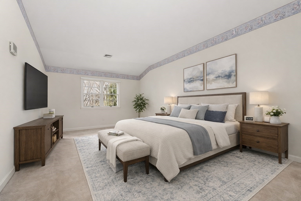 3 Parker Ridge Way, Unit 3 Newburyport, MA 01950 - Photo 16 of 40 a bedroom with a bed and a flat screen tv