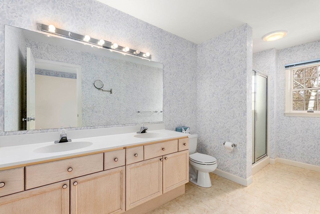 3 Parker Ridge Way, Unit 3 Newburyport, MA 01950 - Photo 18 of 40 a bathroom with a double vanity sink toilet mirror and shower