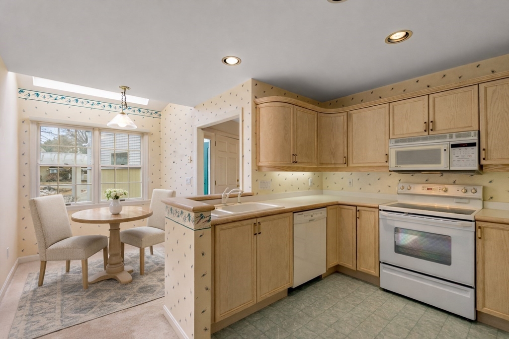 3 Parker Ridge Way, Unit 3 Newburyport, MA 01950 - Photo 7 of 40 a kitchen with a stove sink and cabinets