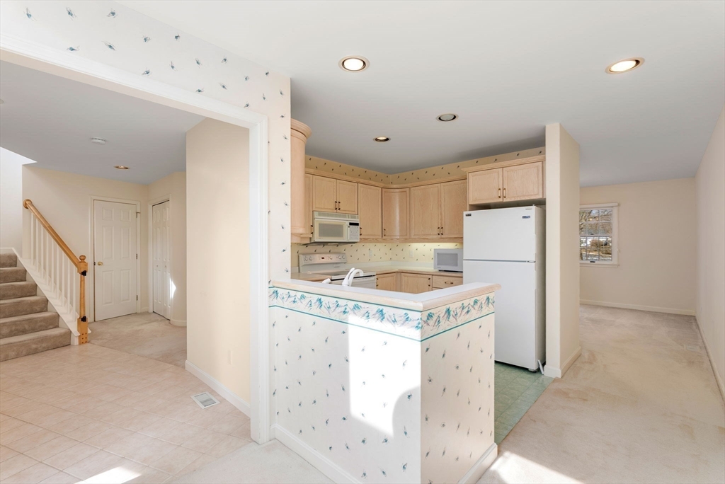 3 Parker Ridge Way, Unit 3 Newburyport, MA 01950 - Photo 8 of 40 a kitchen with a refrigerator a sink and a stove
