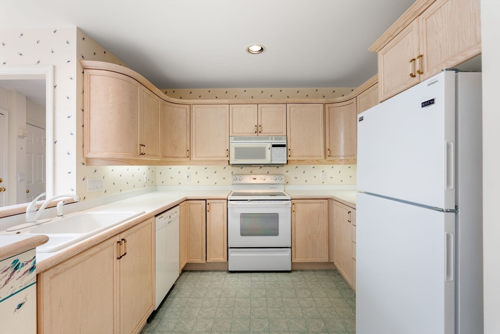 3 Parker Ridge Way, Unit 3 Newburyport, MA 01950 - Photo 9 of 40 a white kitchen with sink and white appliances