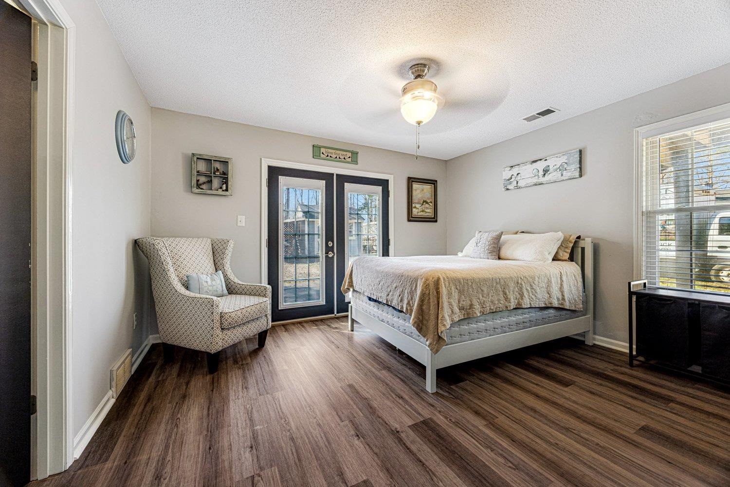 401 North Sanga Road Memphis, TN 38018 - Photo 15 of 27 Bedroom with french doors, access to exterior, dark wood finished floors, ceiling fan, and a textured ceiling